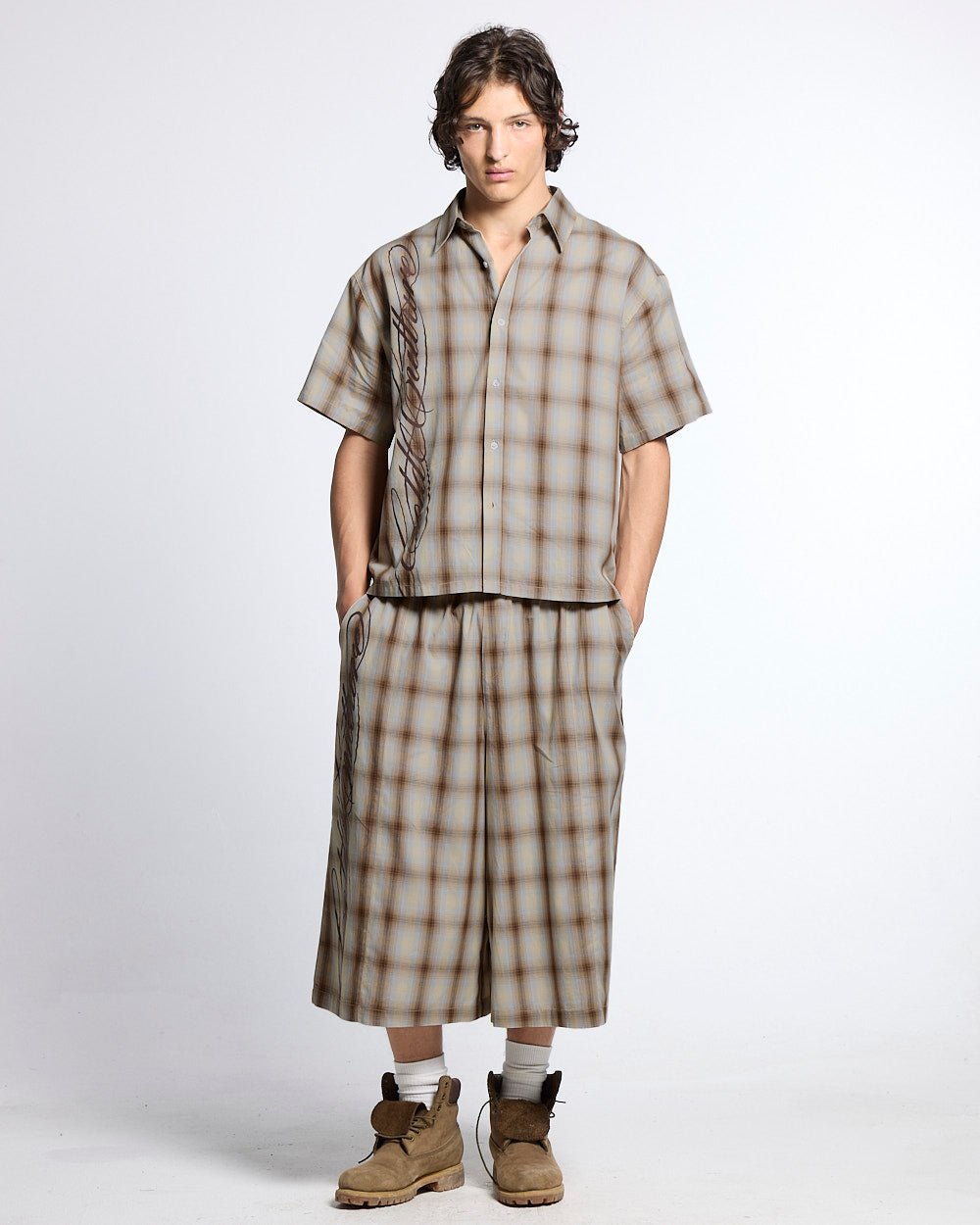 OFFICE SCRIPT SHORTS BEIGE - beige plaid wide leg shorts, front view on male model - Cold Culture #man