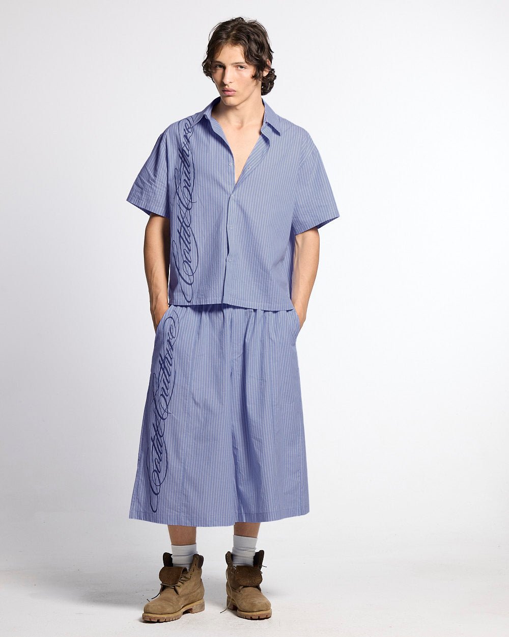 OFFICE SCRIPT SHORTS BLUE - blue striped wide leg shorts, front view on male model - Cold Culture #man