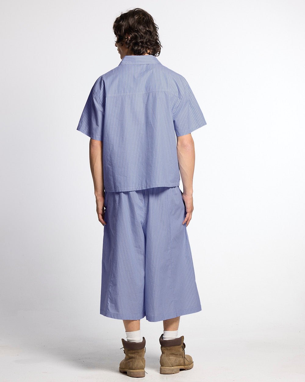 OFFICE SCRIPT SHORTS BLUE - blue striped wide leg shorts, back view on male model - Cold Culture #man