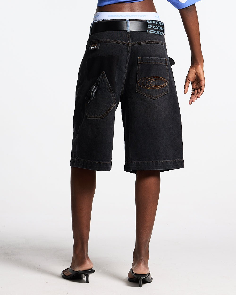POCKET KO SHORTS BLACK DENIM - washed black denim shorts, back view on female model - Cold Culture #woman