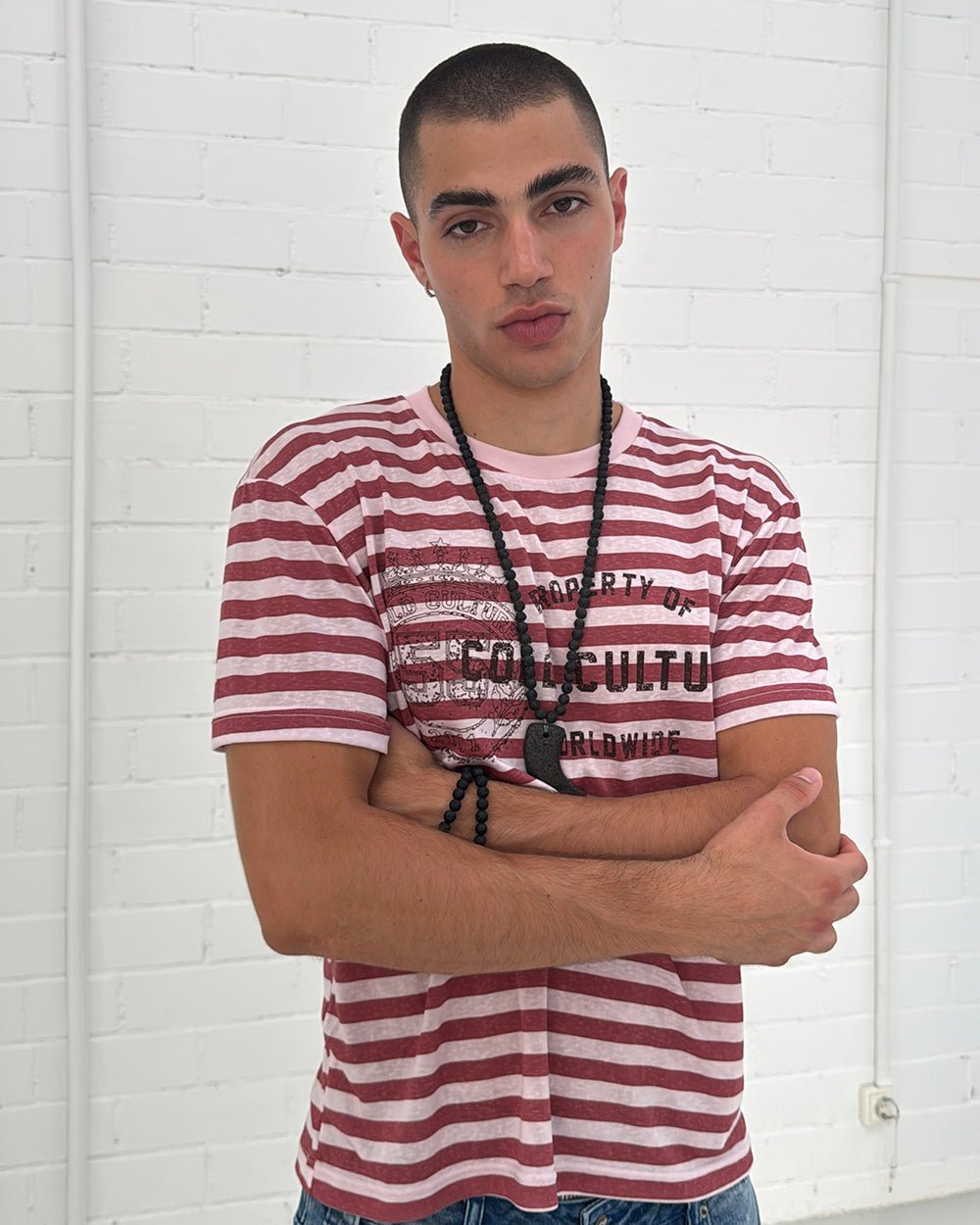 PROPERTY TEE PINK - pink striped tee, front view on male model - Cold Culture