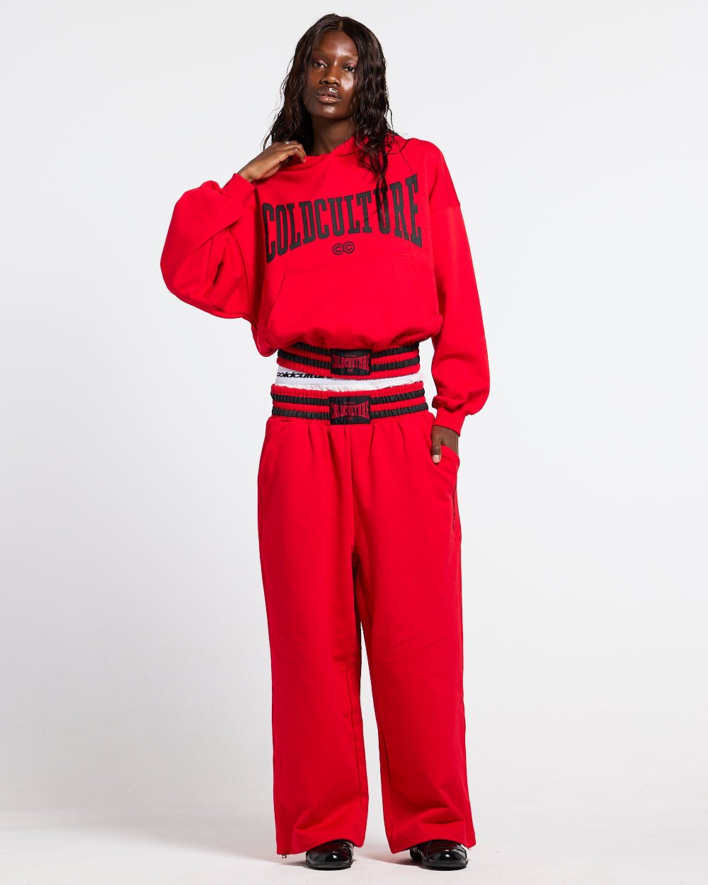 RAGE IN THE RING PANTS RED - red baggy sweatpants, front view on female model - Cold Culture #woman