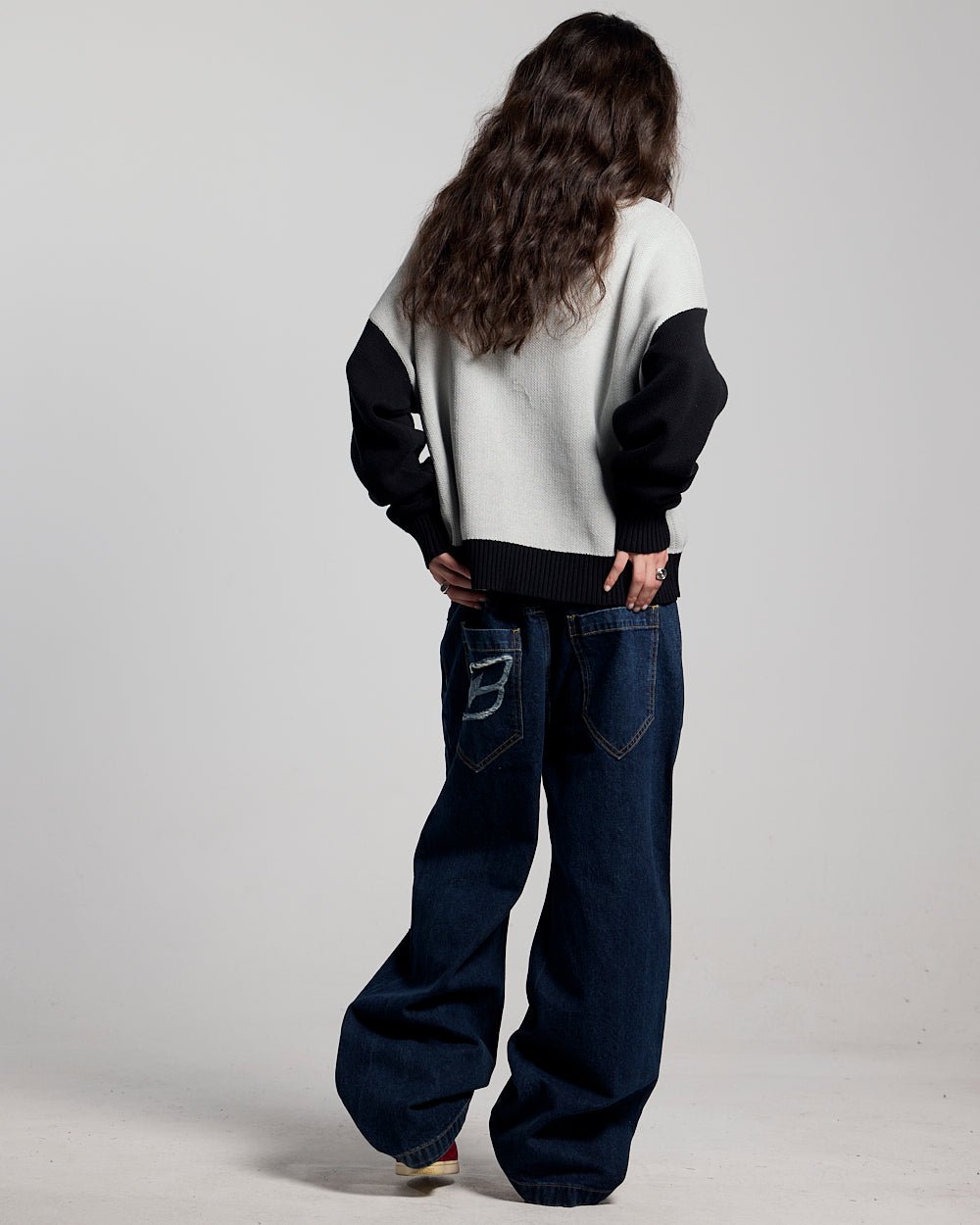 RAGE KNIT GREY - grey and black script knit sweater, back view on female model - Cold Culture #woman