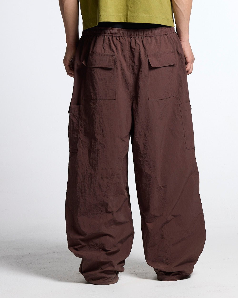 RESERVED CARGO PANTS BROWN - brown nylon cargo pants, back view on male model - Cold Culture