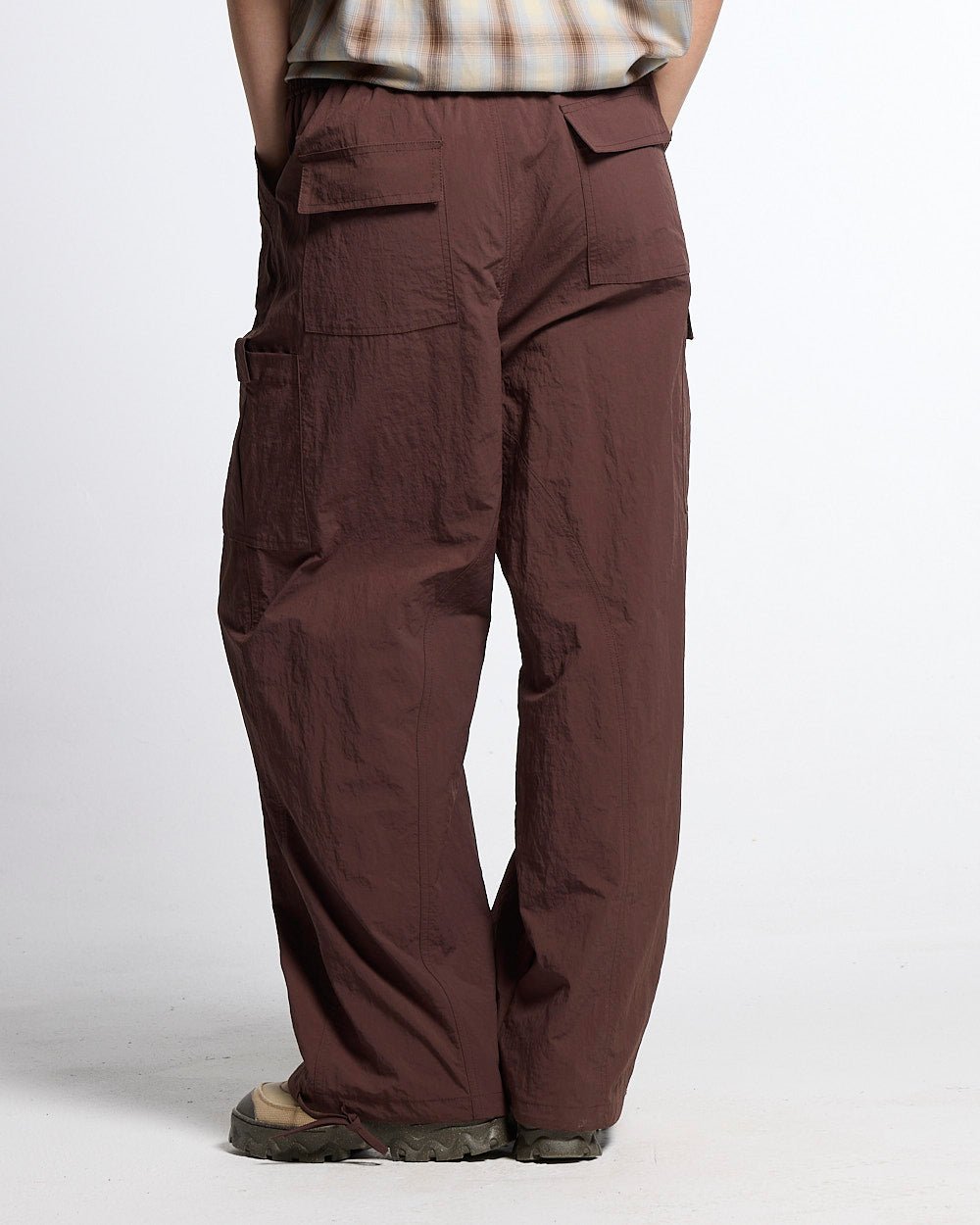 RESERVED CARGO PANTS BROWN - brown nylon cargo pants, back view on female model - Cold Culture