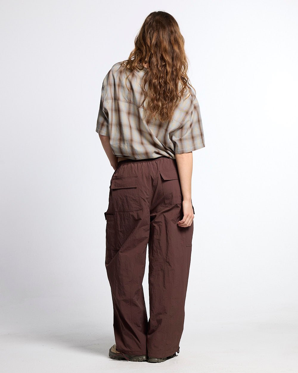 RESERVED CARGO PANTS BROWN - brown nylon cargo pants, back view on female model - Cold Culture #woman