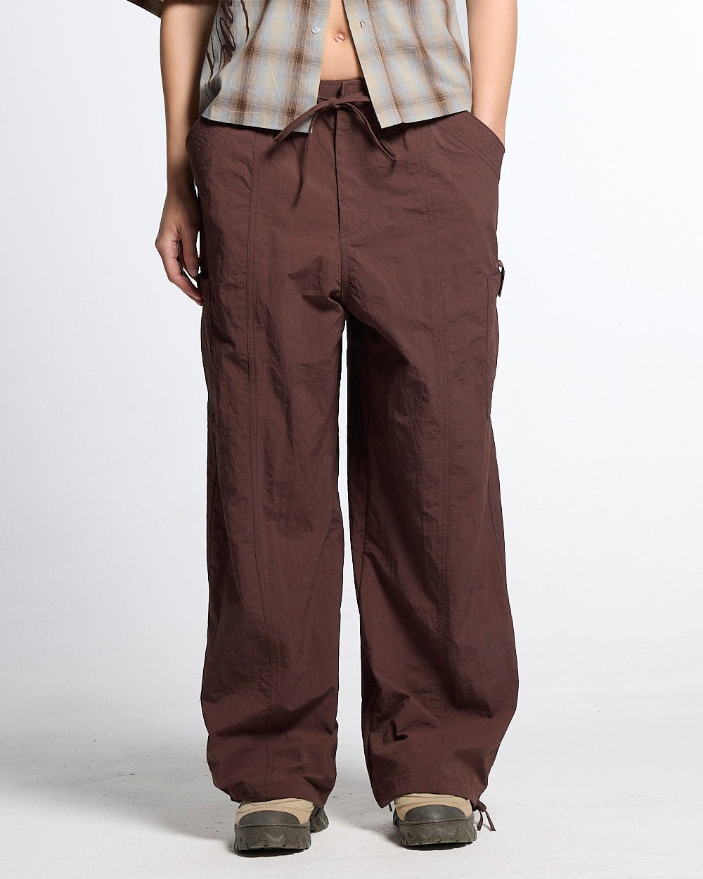 RESERVED CARGO PANTS BROWN - brown nylon cargo pants, front view on female model - Cold Culture