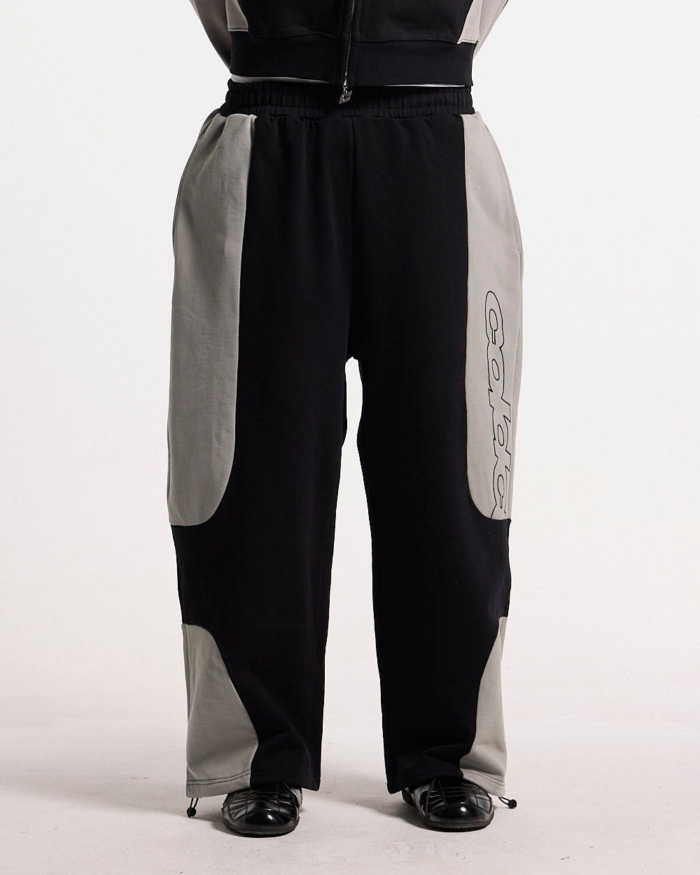 RIDER SWEATPANTS BLACK & GREY - black and grey paneled sweatpants, front view on male model - Cold Culture