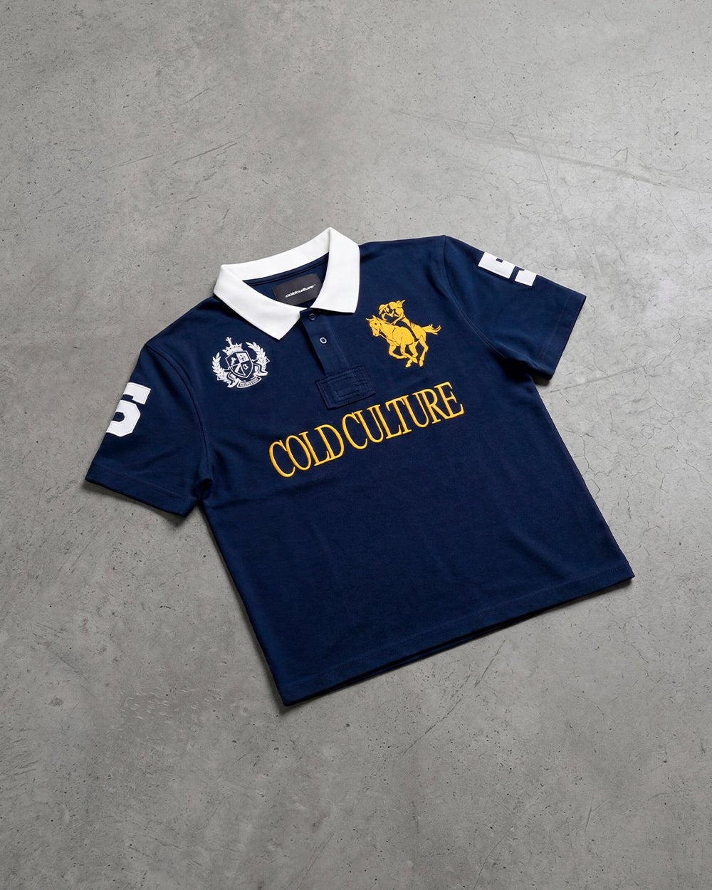 RIDING CLUB POLO NAVY - navy embroidered polo shirt, flat lay - Cold Culture