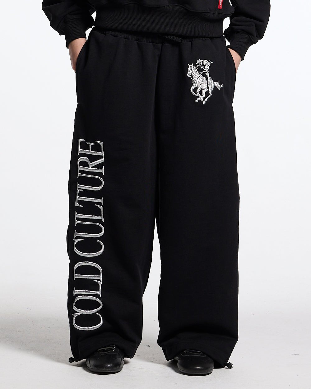 RIDING CLUB SWEATPANTS BLACK - black embroidered sweatpants, front view on male model - Cold Culture