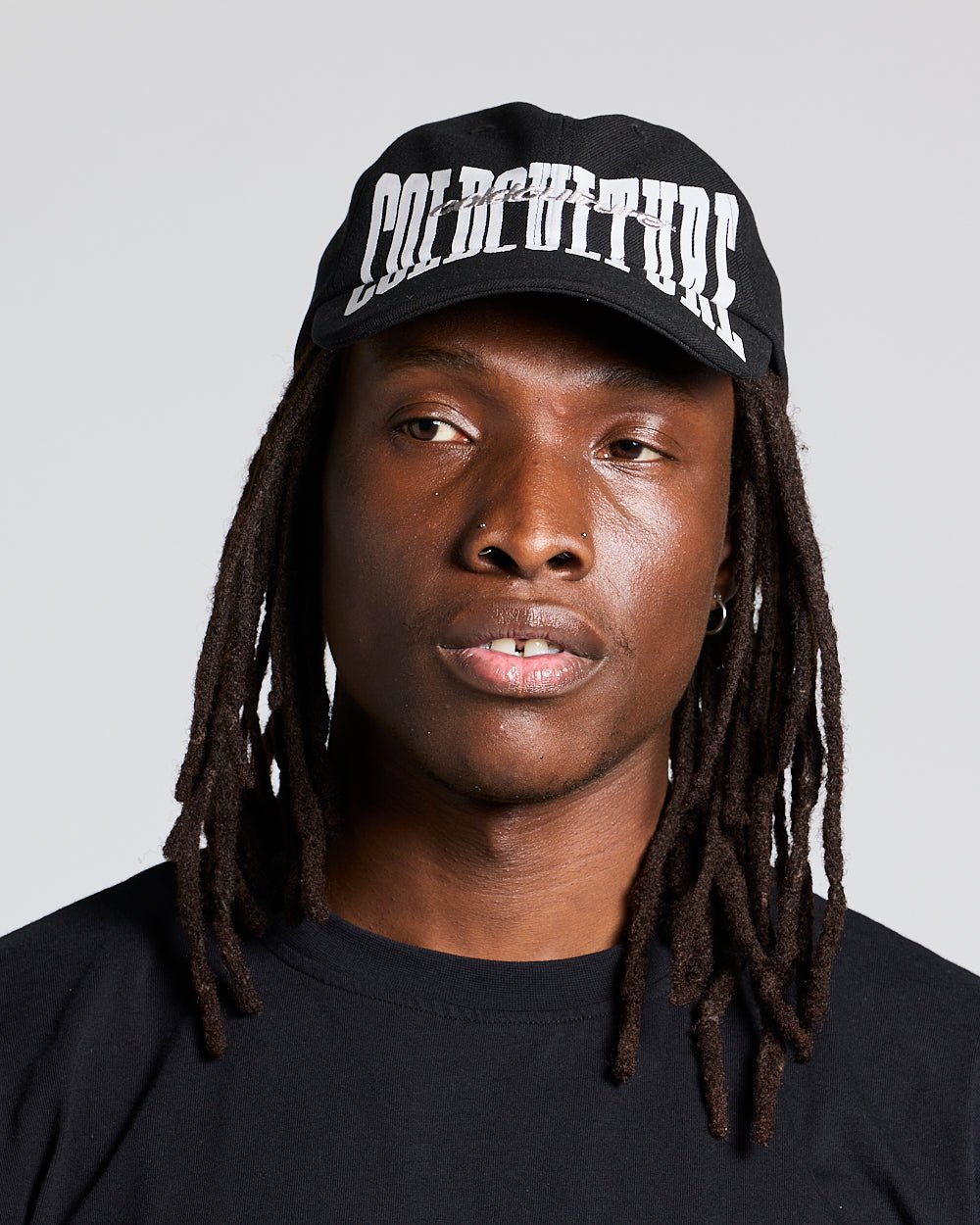 RIOT CAP BLACK - black logo print cap, on model close-up - Cold Culture #man