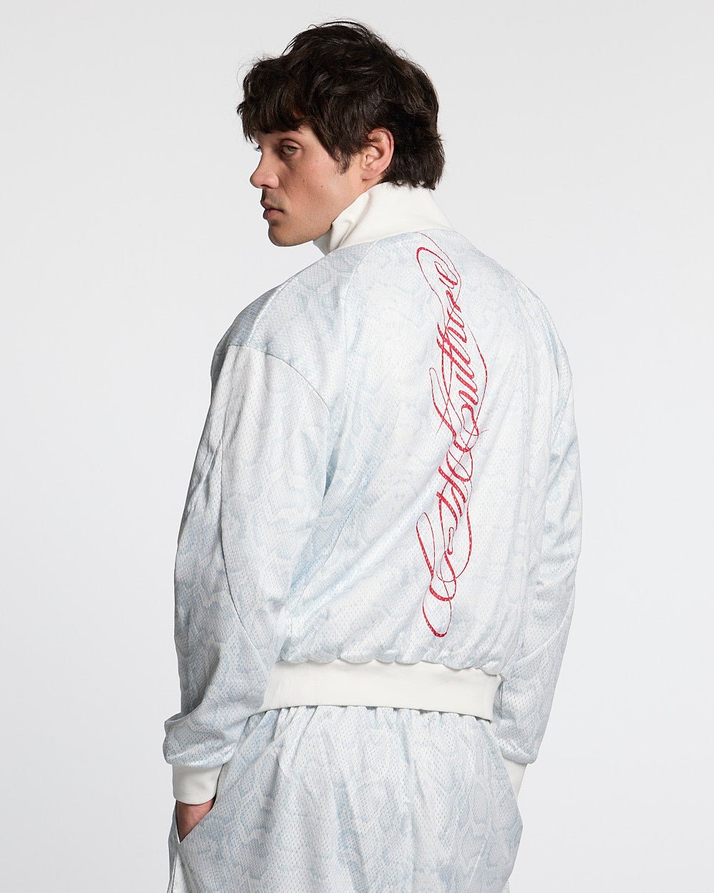 RIOT MESH JACKET WHITE - white snakeskin print track jacket, back view on male model - Cold Culture #man