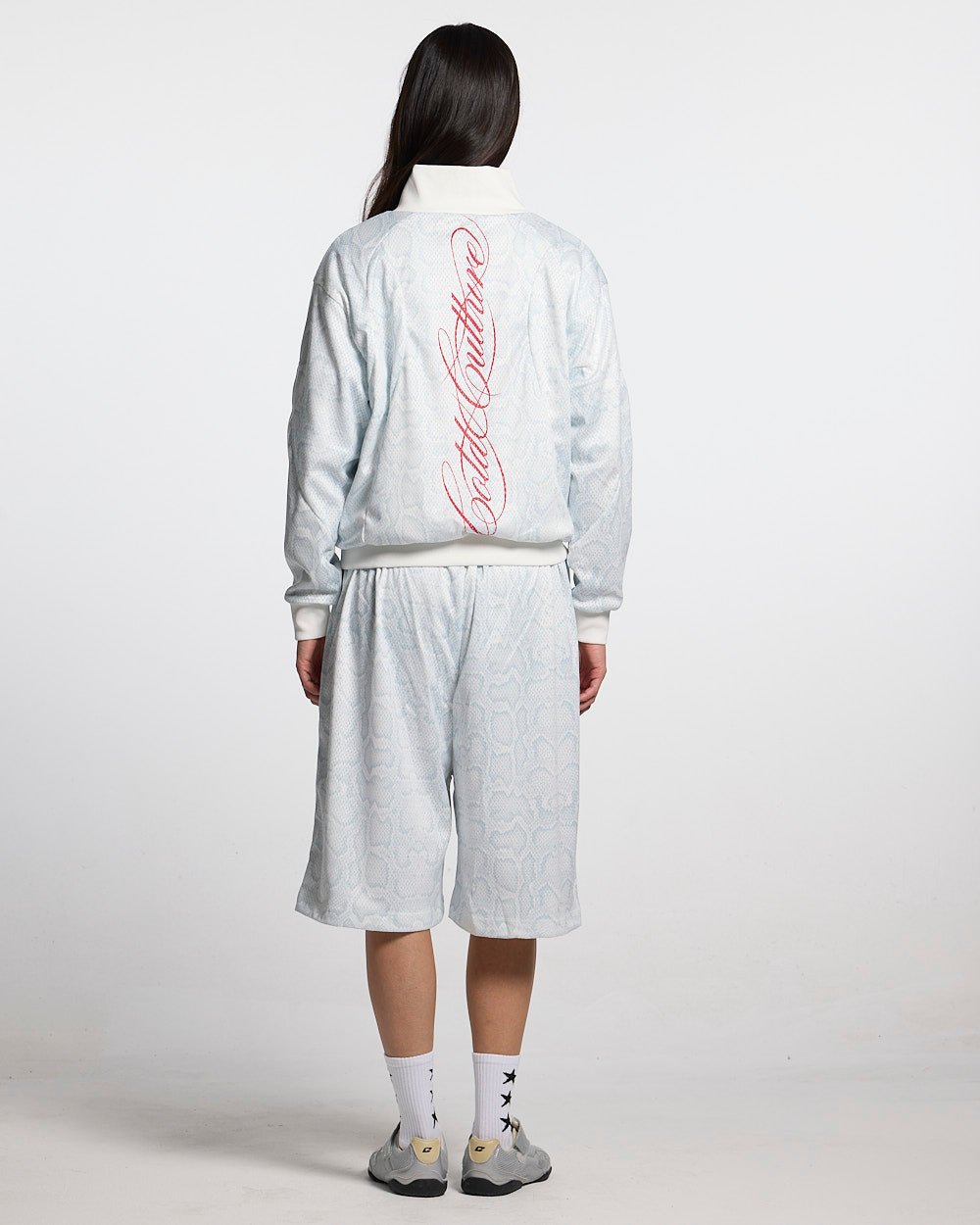 RIOT MESH JACKET WHITE - white snakeskin print track jacket, back view on female model - Cold Culture #woman