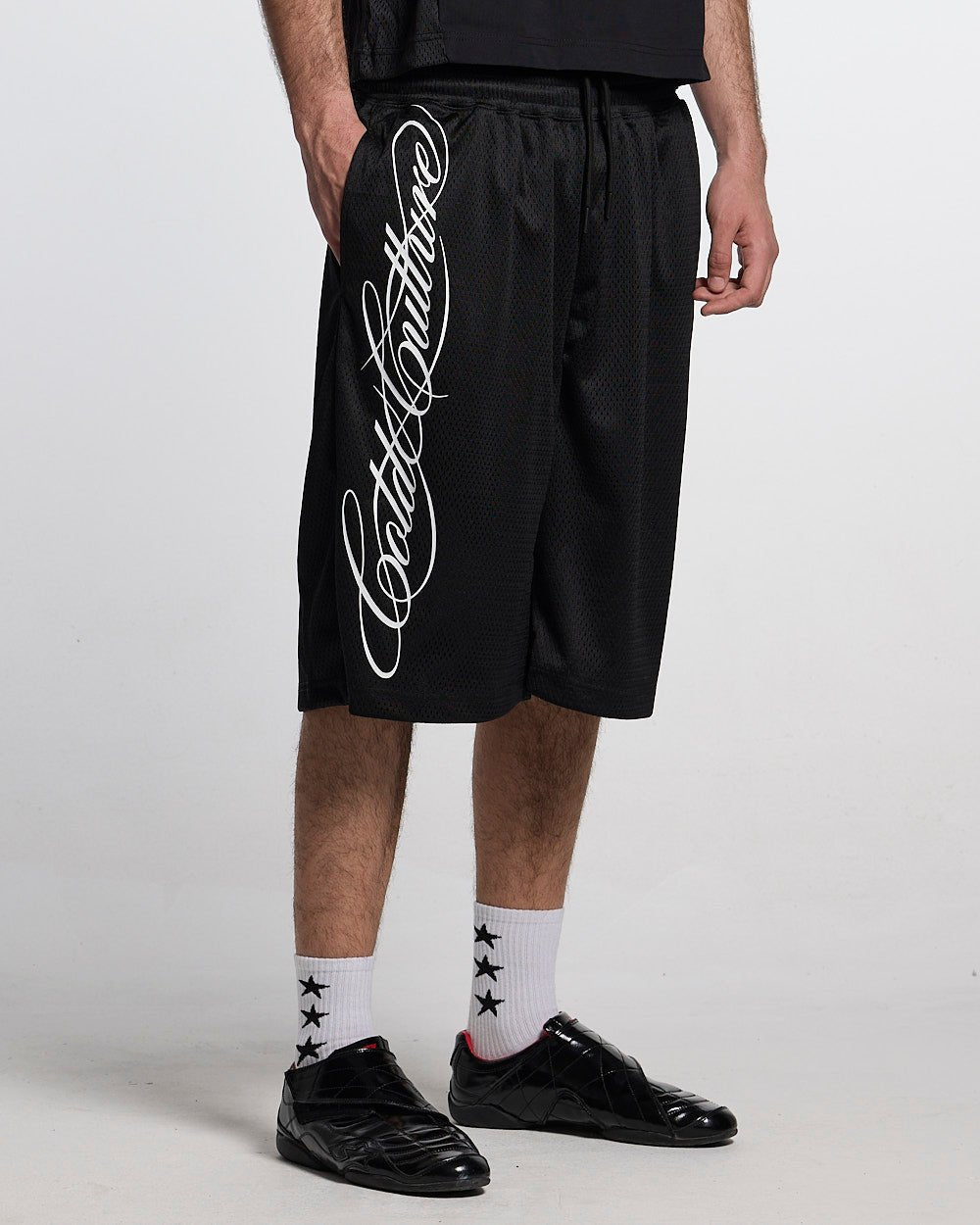 RIOT MESH SHORT BLACK - black mesh shorts, front view on male model - Cold Culture