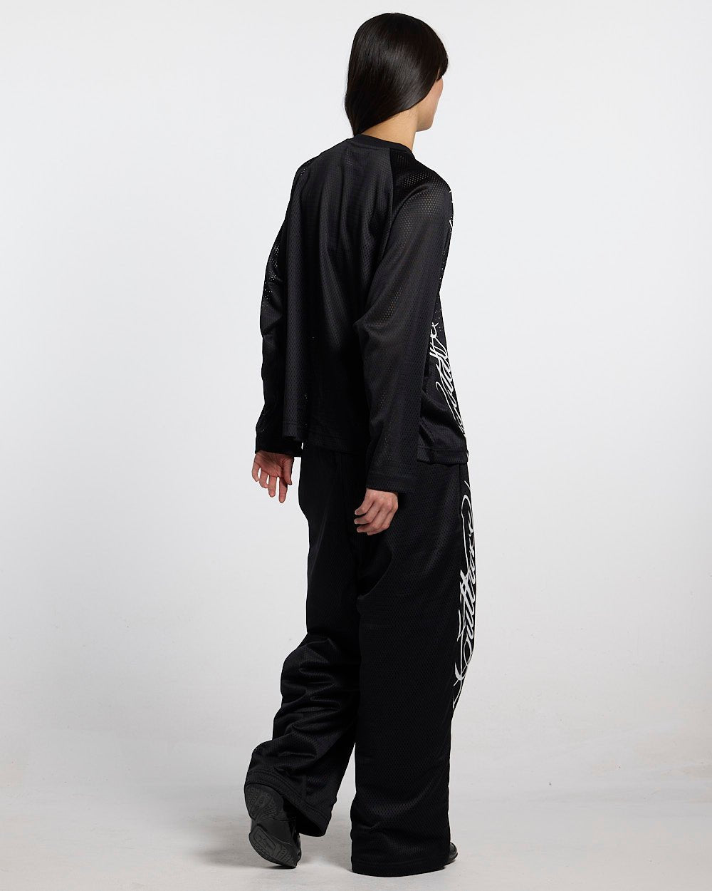 RIOT MESH SWEATPANTS BLACK - black mesh sweatpants, back view on female model - Cold Culture #woman