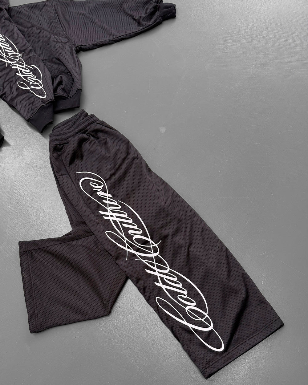 RIOT MESH SWEATPANTS BLACK - black mesh sweatpants, flat lay with matching pieces - Cold Culture