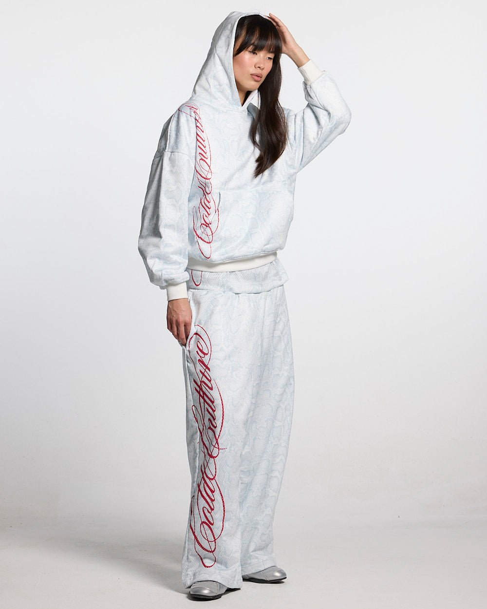 RIOT MESH SWEATPANTS WHITE - white snakeskin print sweatpants, front view on female model - Cold Culture #woman