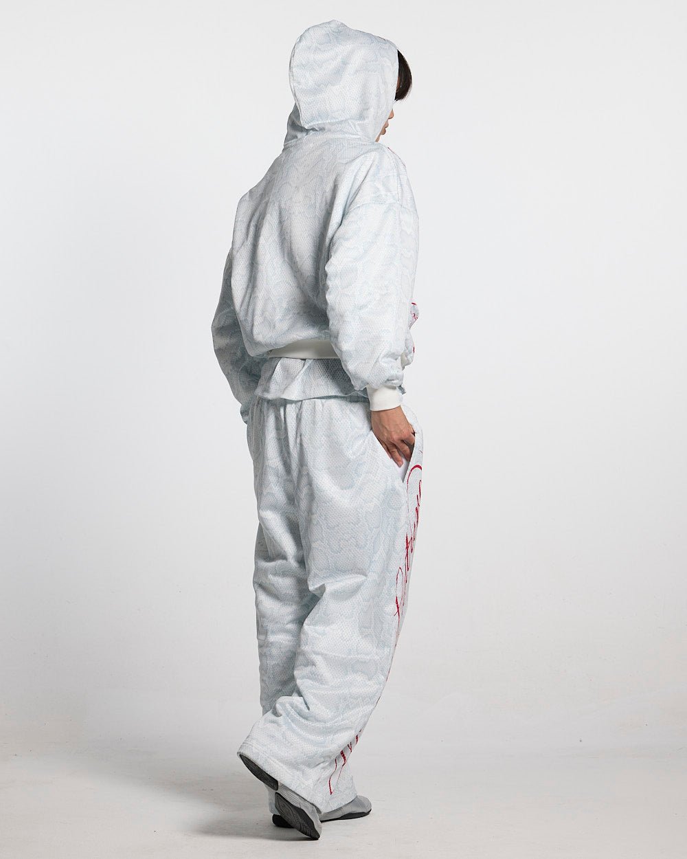 RIOT MESH SWEATPANTS WHITE - white snakeskin print sweatpants, back view on female model - Cold Culture #woman