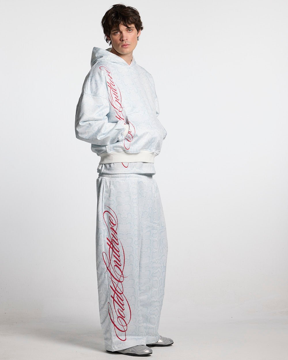 RIOT MESH SWEATPANTS WHITE - white snakeskin print sweatpants, front view on male model - Cold Culture #man