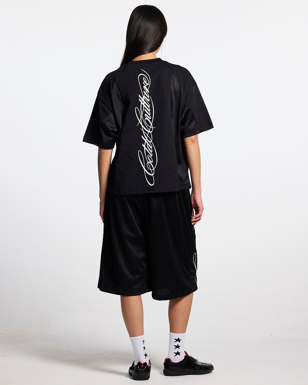 RIOT MESH TEE BLACK - black mesh panel tee, back view on female model - Cold Culture #woman