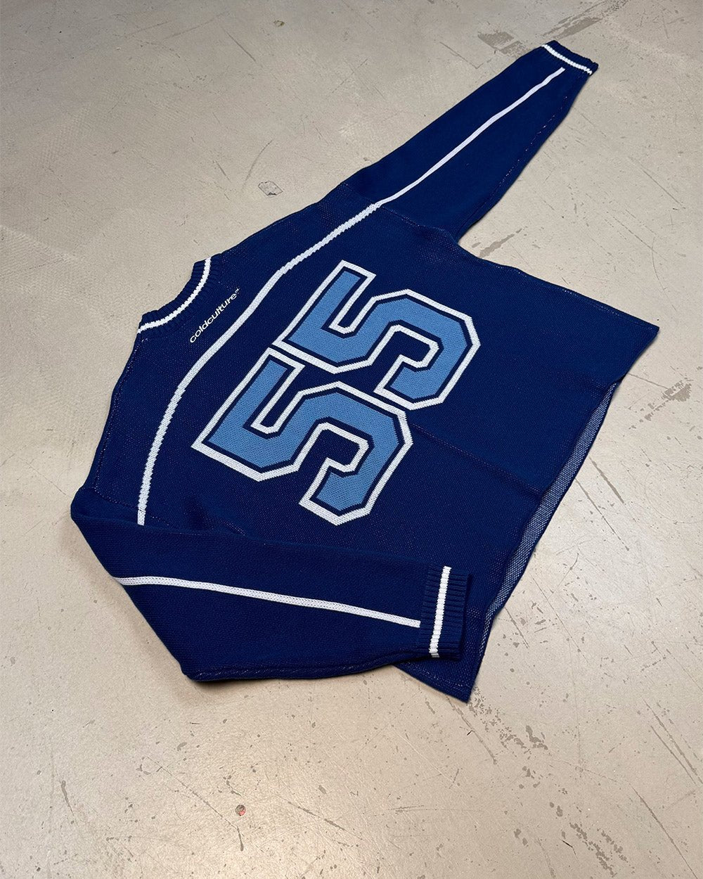 ROLLER KNIT BLUE - blue varsity knit sweater, flat lay - Cold Culture