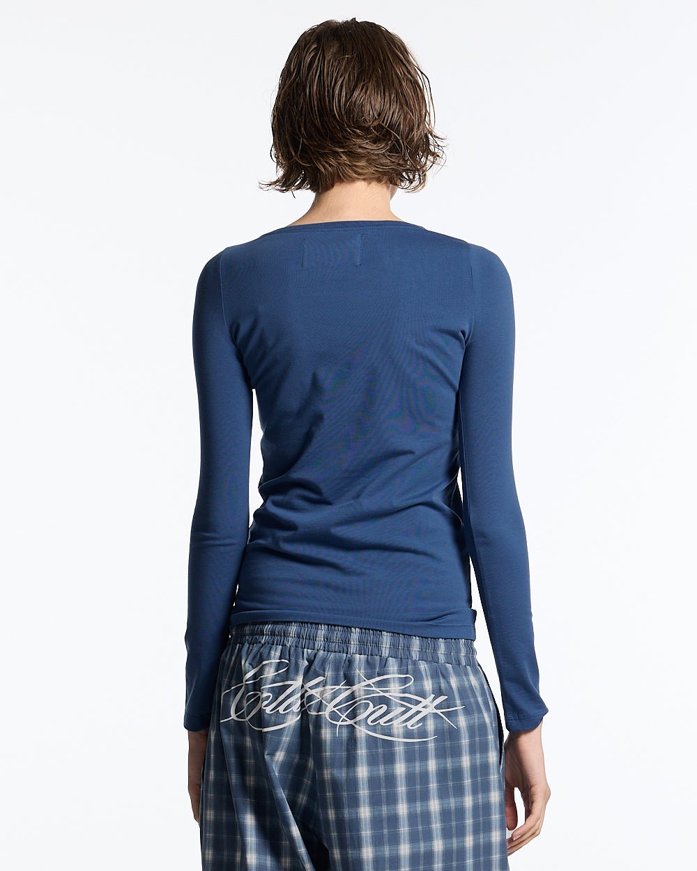 ROUGH LONGSLEEVE TEE BLUE - blue script print longsleeve tee, back view on female model - Cold Culture #woman