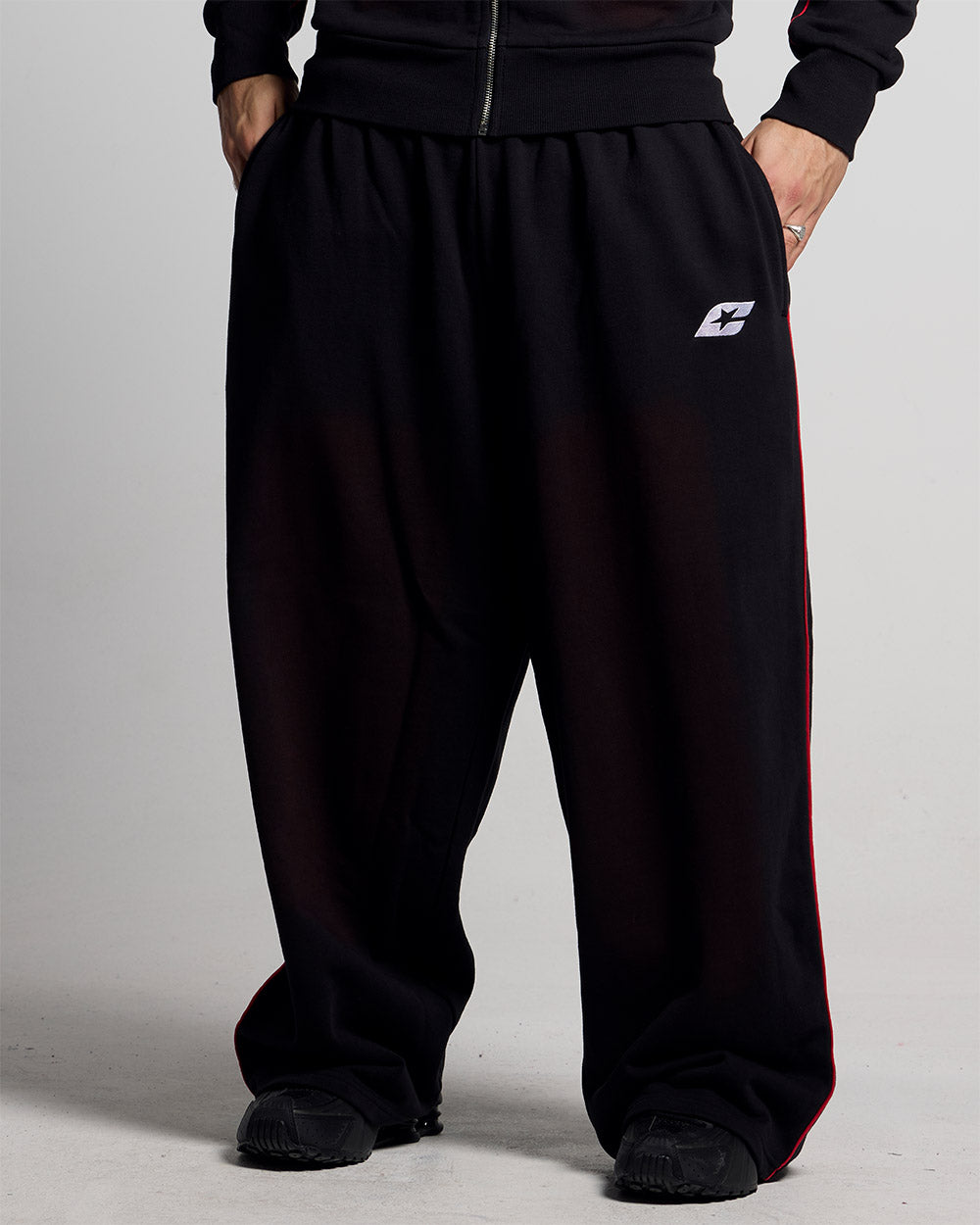SAVAGE WASHED PANTS BLACK & RED - black and red washed sweatpants, front view on male model - Cold Culture
