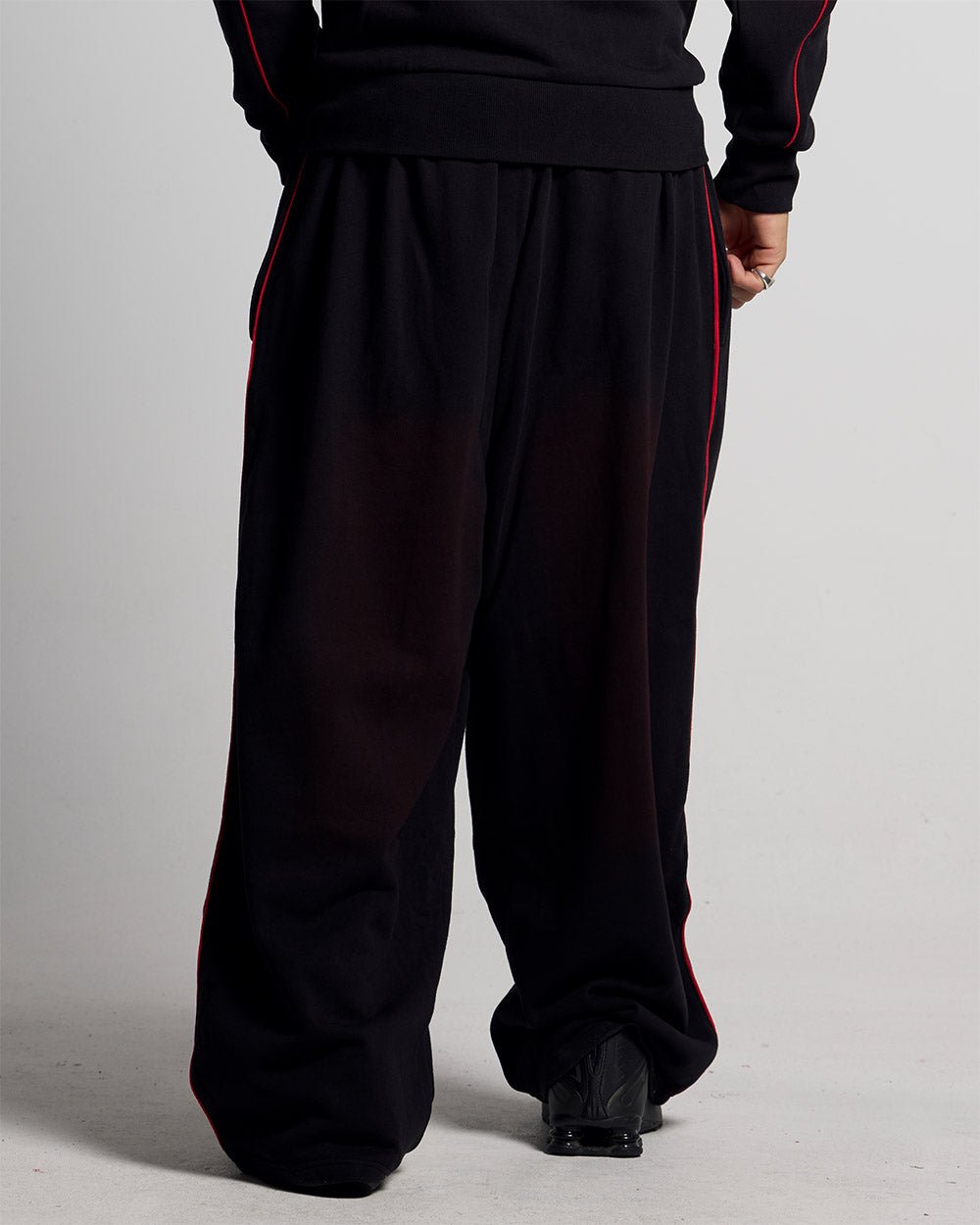 SAVAGE WASHED PANTS BLACK & RED - black and red washed sweatpants, back view on male model - Cold Culture