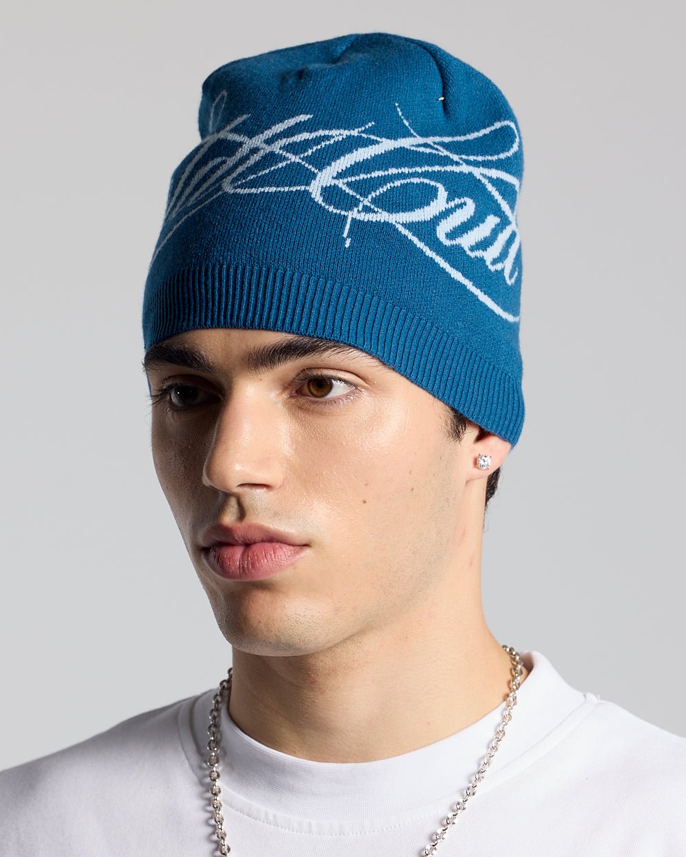 SCRIPT BEANIE BLUE - blue script knit beanie, on model close-up - Cold Culture #man