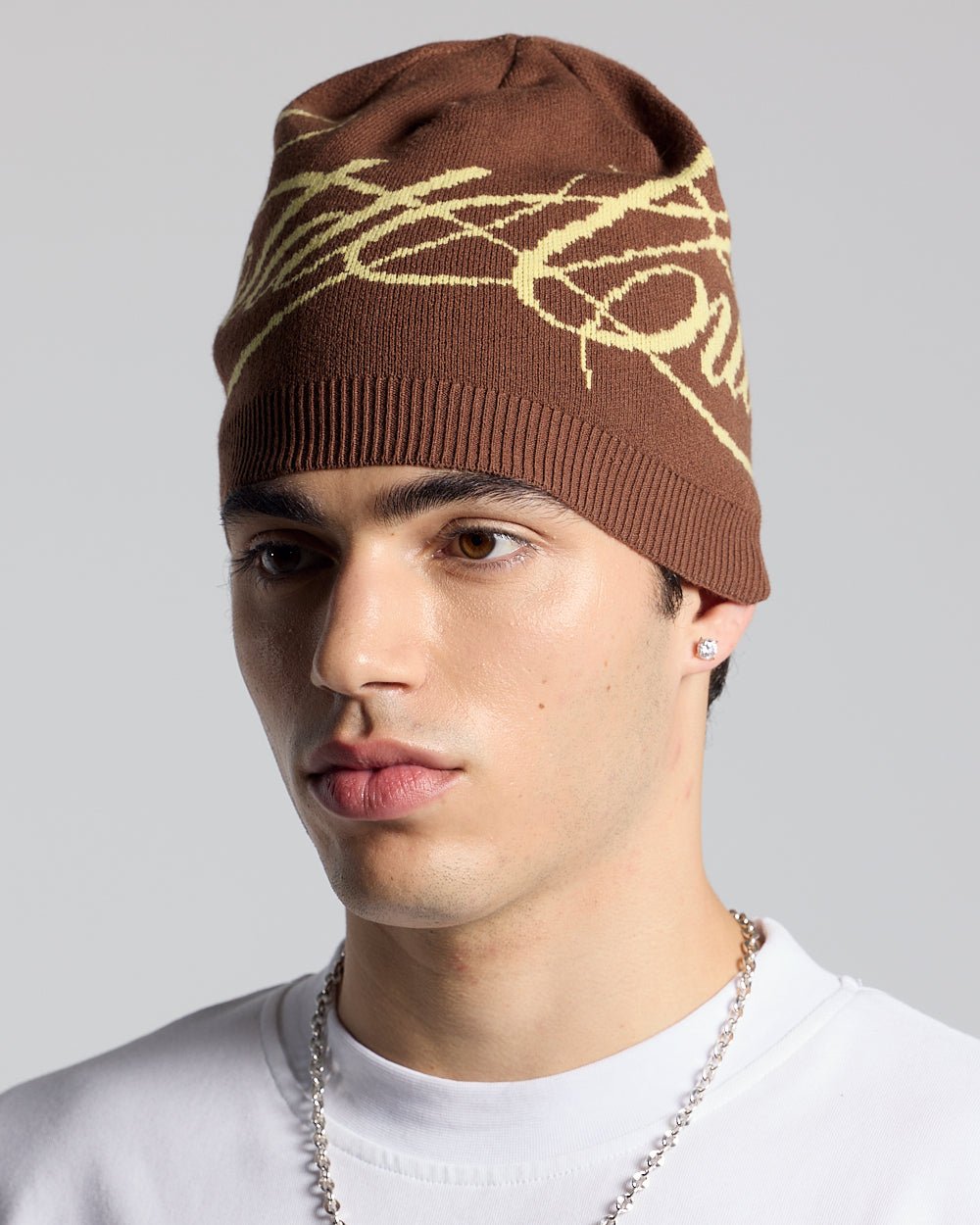 SCRIPT BEANIE BROWN - brown script knit beanie, on model close-up - Cold Culture #man