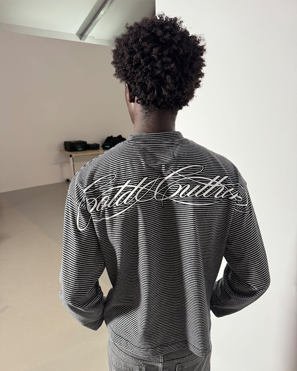 SCRIPT STRIPES LONGSLEEVE BLACK - black striped longsleeve tee, back view on male model - Cold Culture