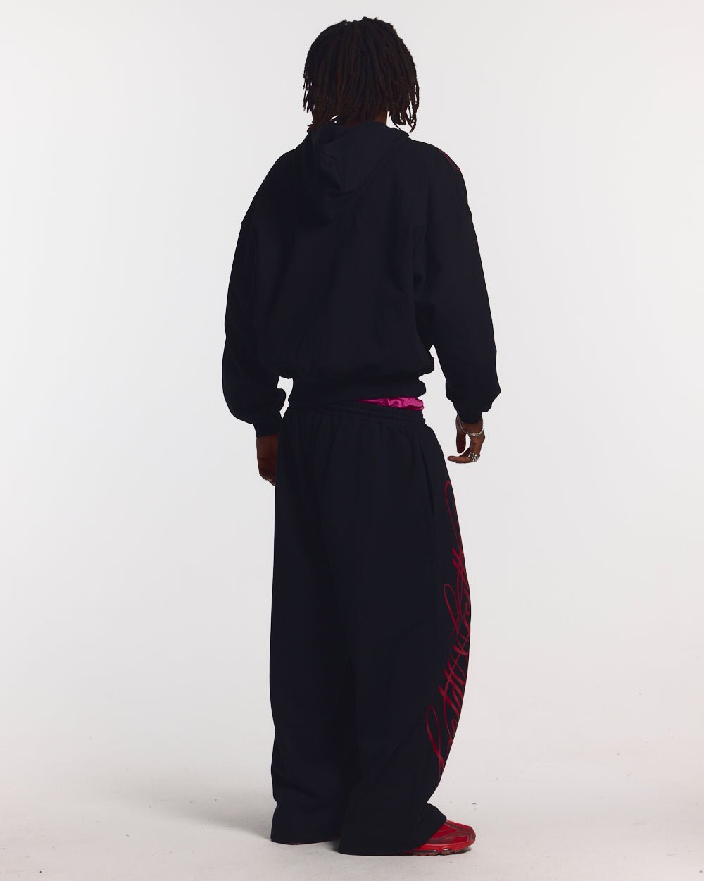 SCRIPT SWEATPANTS BLACK - black graphic print sweatpants, back view on male model - Cold Culture #man