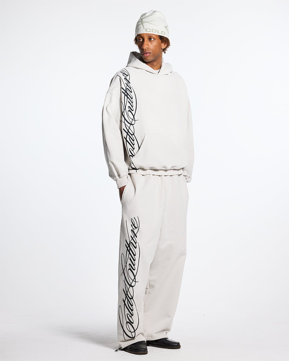 SCRIPT SWEATPANTS LIGHT GREY - light grey script print sweatpants, front view on male model - Cold Culture #man