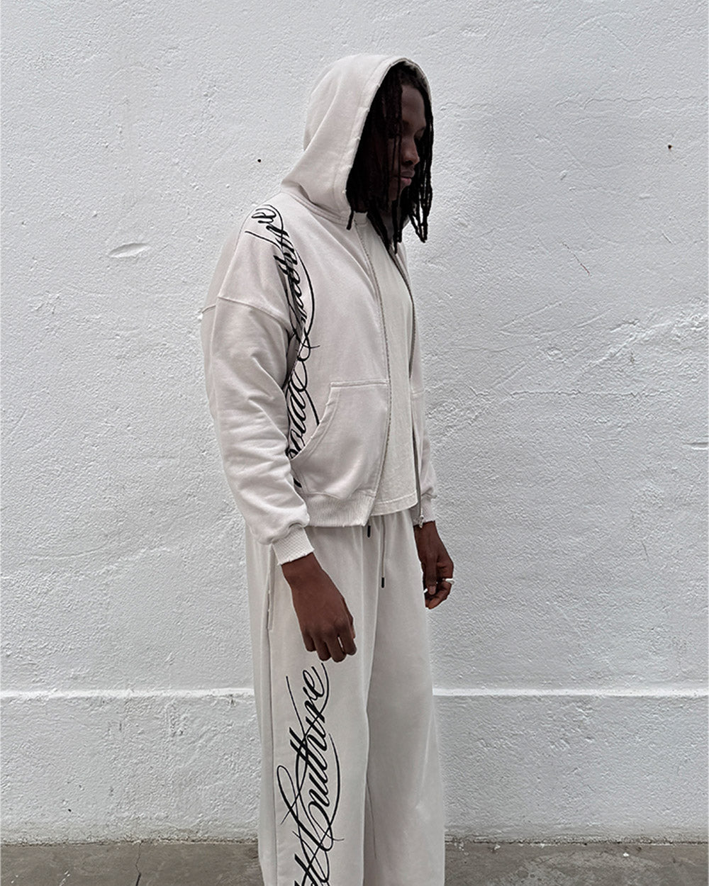 SCRIPT SWEATPANTS LIGHT GREY - light grey script print sweatpants, street style shot - Cold Culture