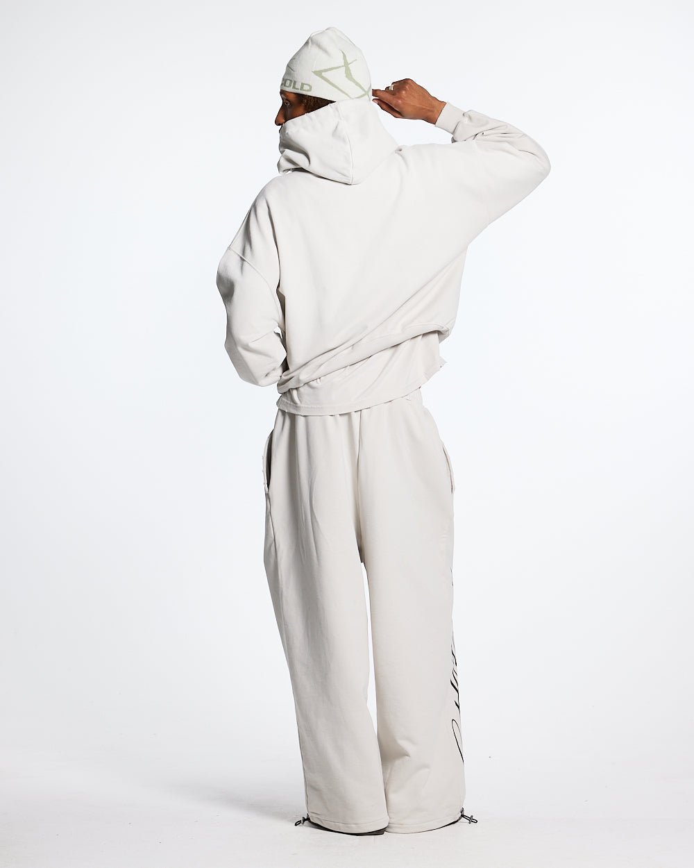 SCRIPT SWEATPANTS LIGHT GREY - light grey script print sweatpants, back view on male model - Cold Culture