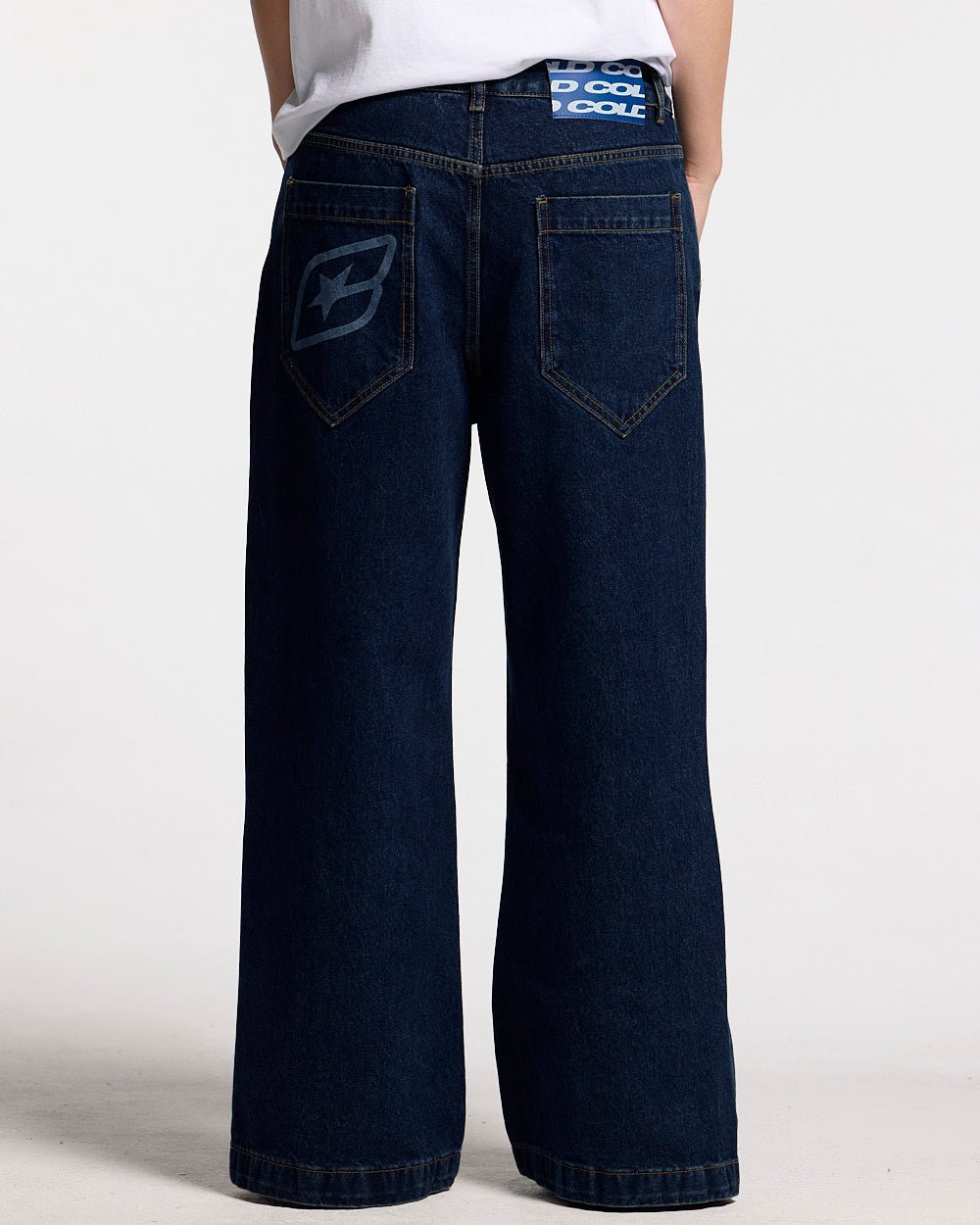 SCRIPT V3 PANTS RAW DENIM - dark blue baggy denim pants, back view on female model - Cold Culture #woman