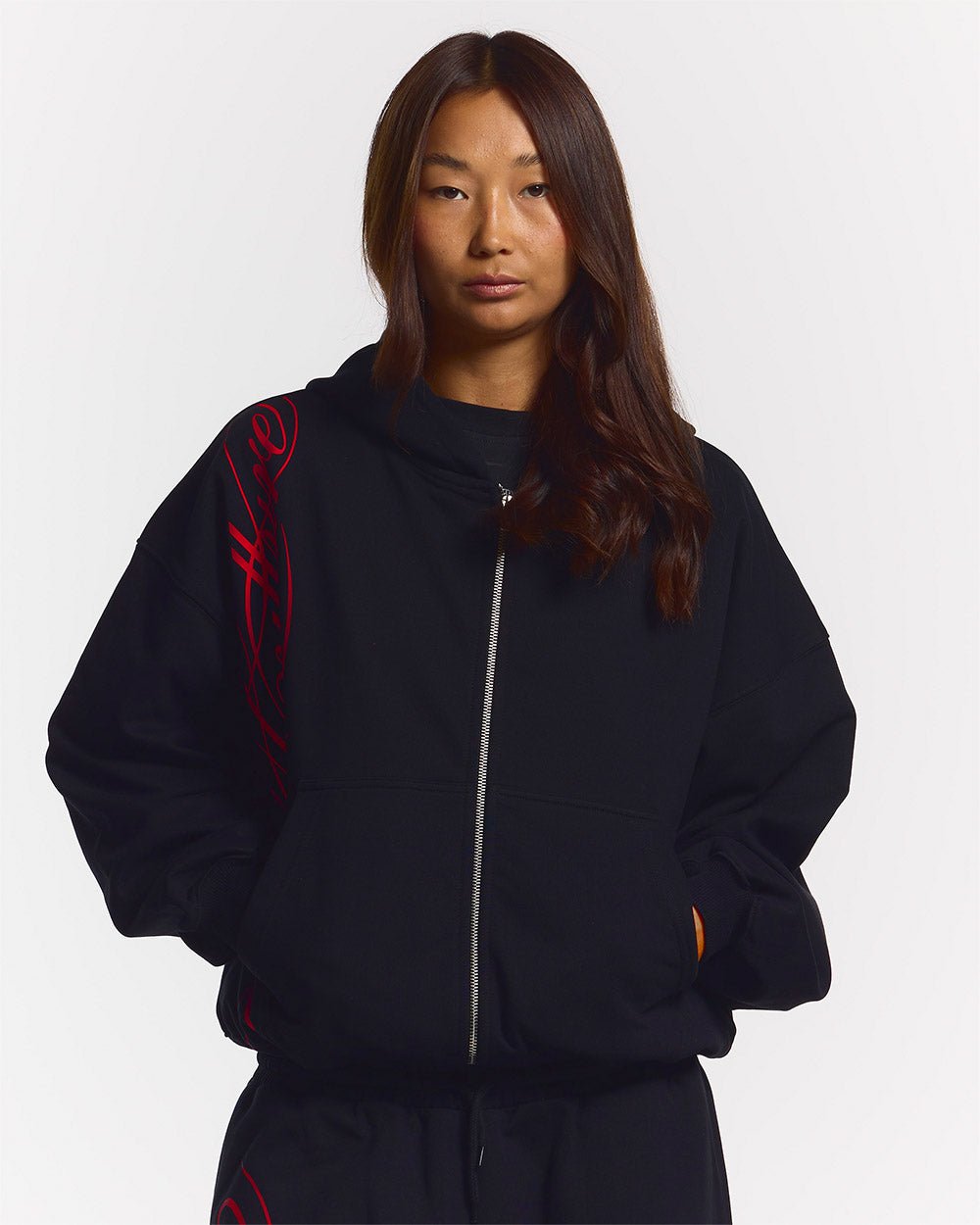 SCRIPT ZIP HOODIE BLACK - black graphic print zip-up hoodie, front view on female model - Cold Culture #woman