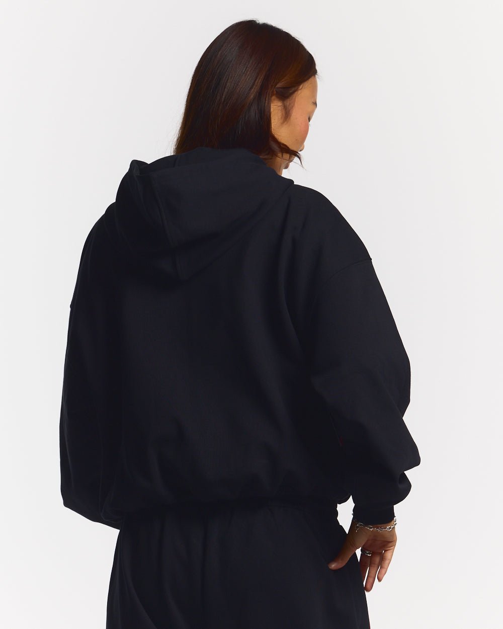 SCRIPT ZIP HOODIE BLACK - black graphic print zip-up hoodie, back view on female model - Cold Culture #woman