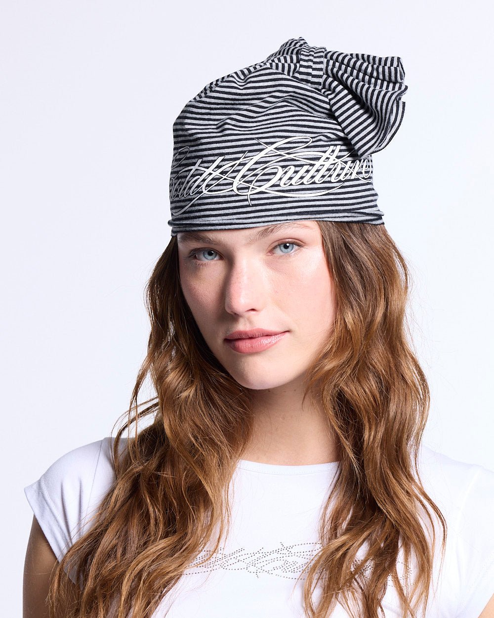SCRIPTED STRIPES KNOT BEANIE BLACK - black striped knot beanie, front view on female model - Cold Culture #woman