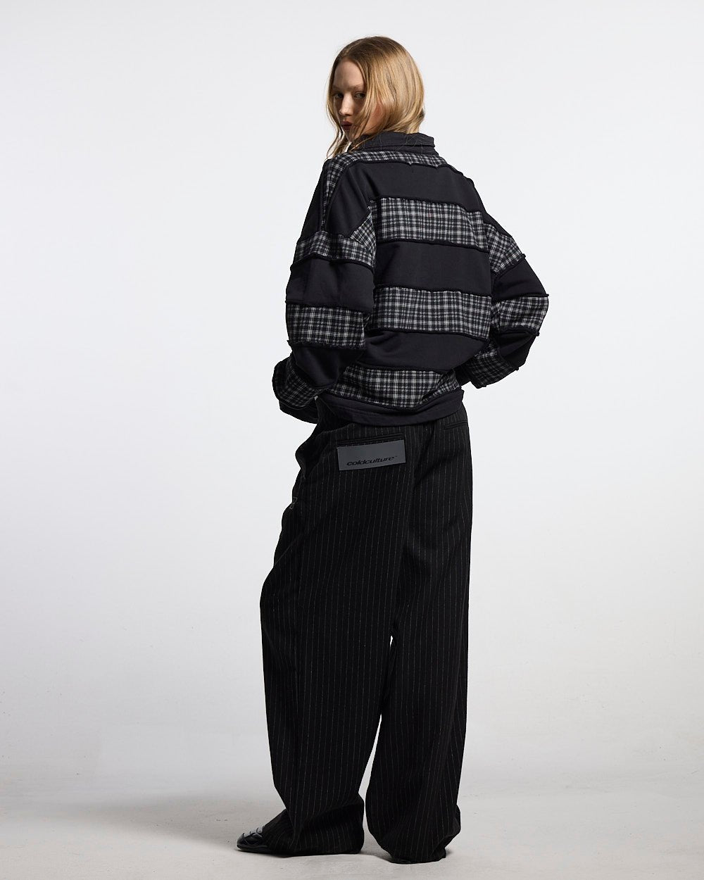 SEAM EFFECT LINE PANTS BLACK - black pinstripe pants, back view on female model - Cold Culture #woman