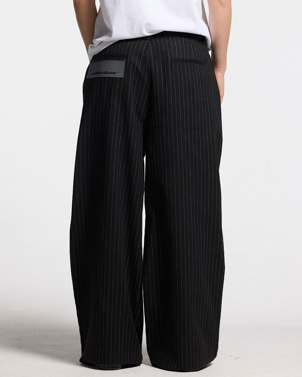 SEAM EFFECT LINE PANTS BLACK - black pinstripe pants, back view on female model - Cold Culture #woman