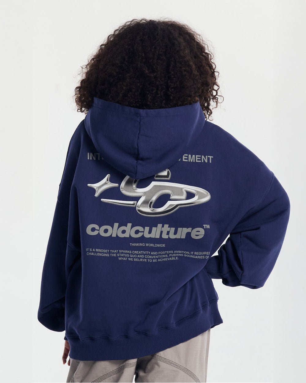 SPARKLY HOODIE COSMIC BLUE - navy blue oversized hoodie, back view on female model - Cold Culture #woman