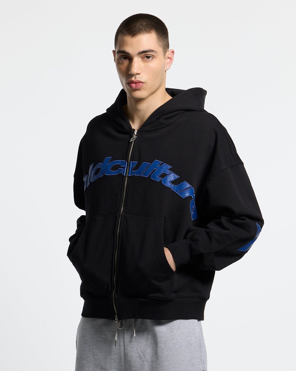 STAR CURVED ZIP HOODIE BLACK - black zip-up hoodie, front view on male model - Cold Culture #man