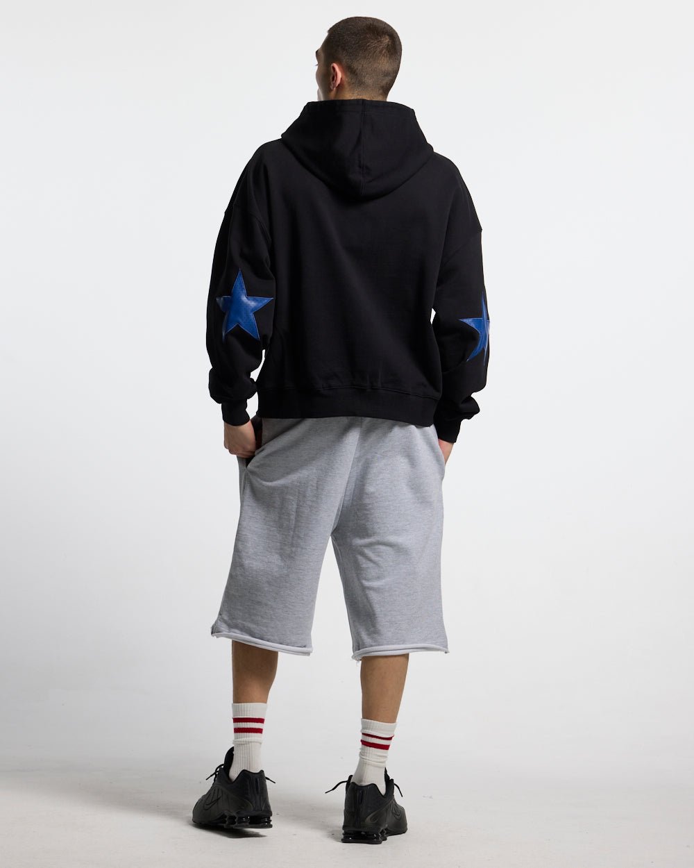 STAR CURVED ZIP HOODIE BLACK - black zip-up hoodie, back view on male model - Cold Culture #man