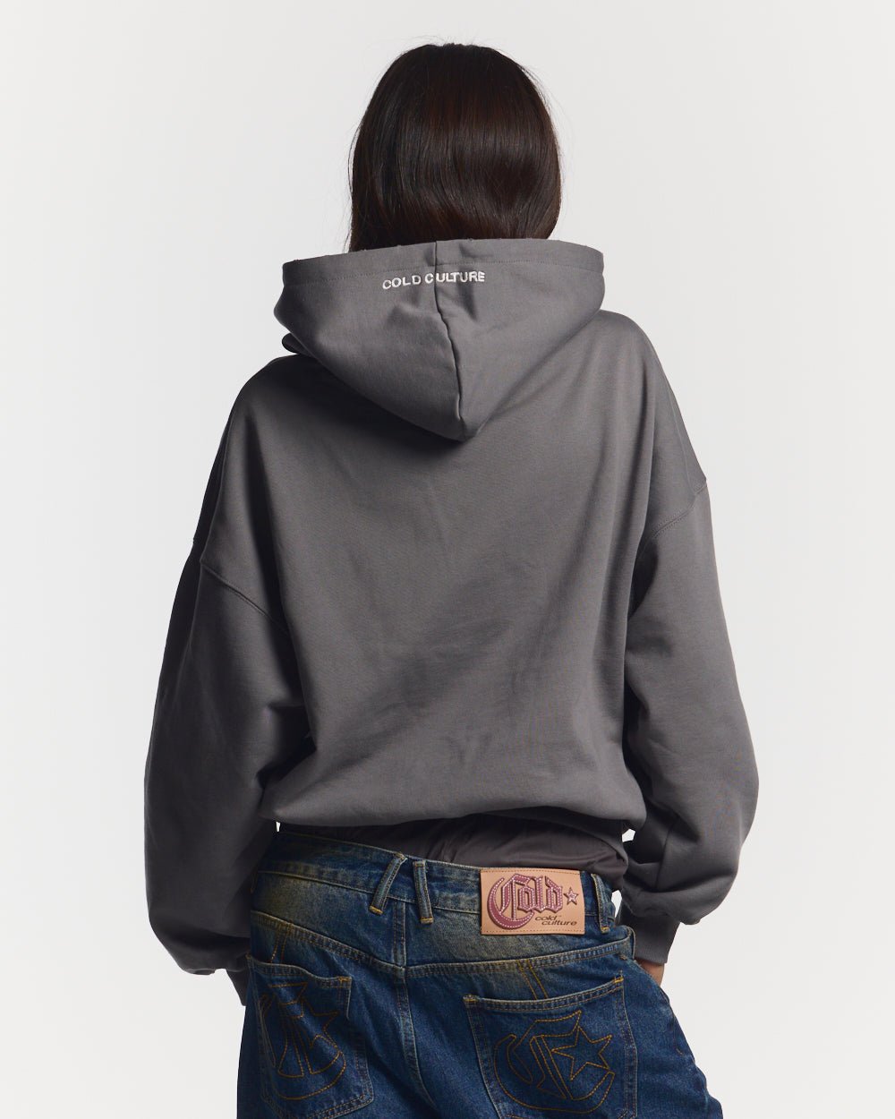 STARS HOODIE DUST GREY - dust grey oversized hoodie, back view on female model - Cold Culture #woman