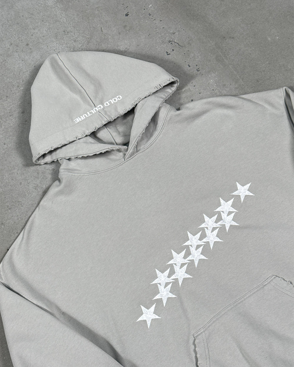 STARS HOODIE PALE GREY - pale grey star print hoodie, detail close-up - Cold Culture
