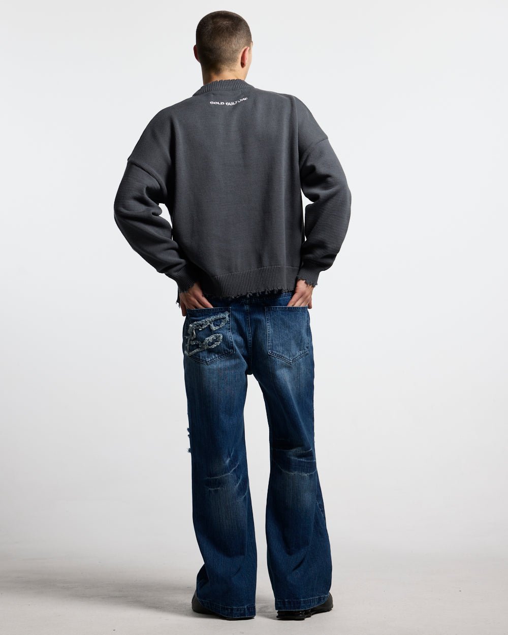 STARS KNIT INDIA INK - charcoal distressed knit sweater, back view on male model - Cold Culture #man