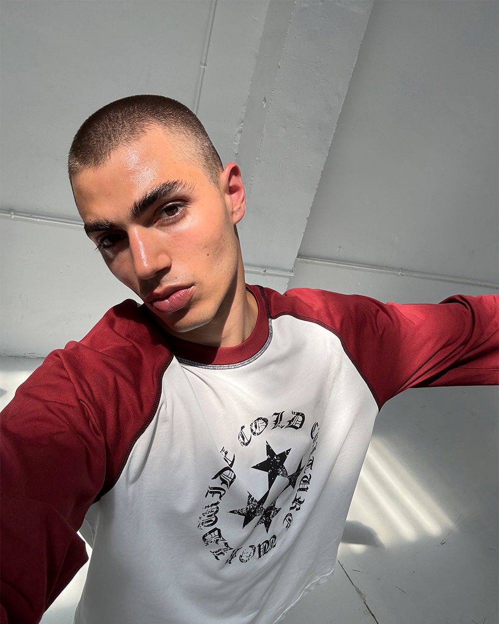STARSHIELD LONGSLEEVE RED - white and red raglan longsleeve tee, on model close-up - Cold Culture