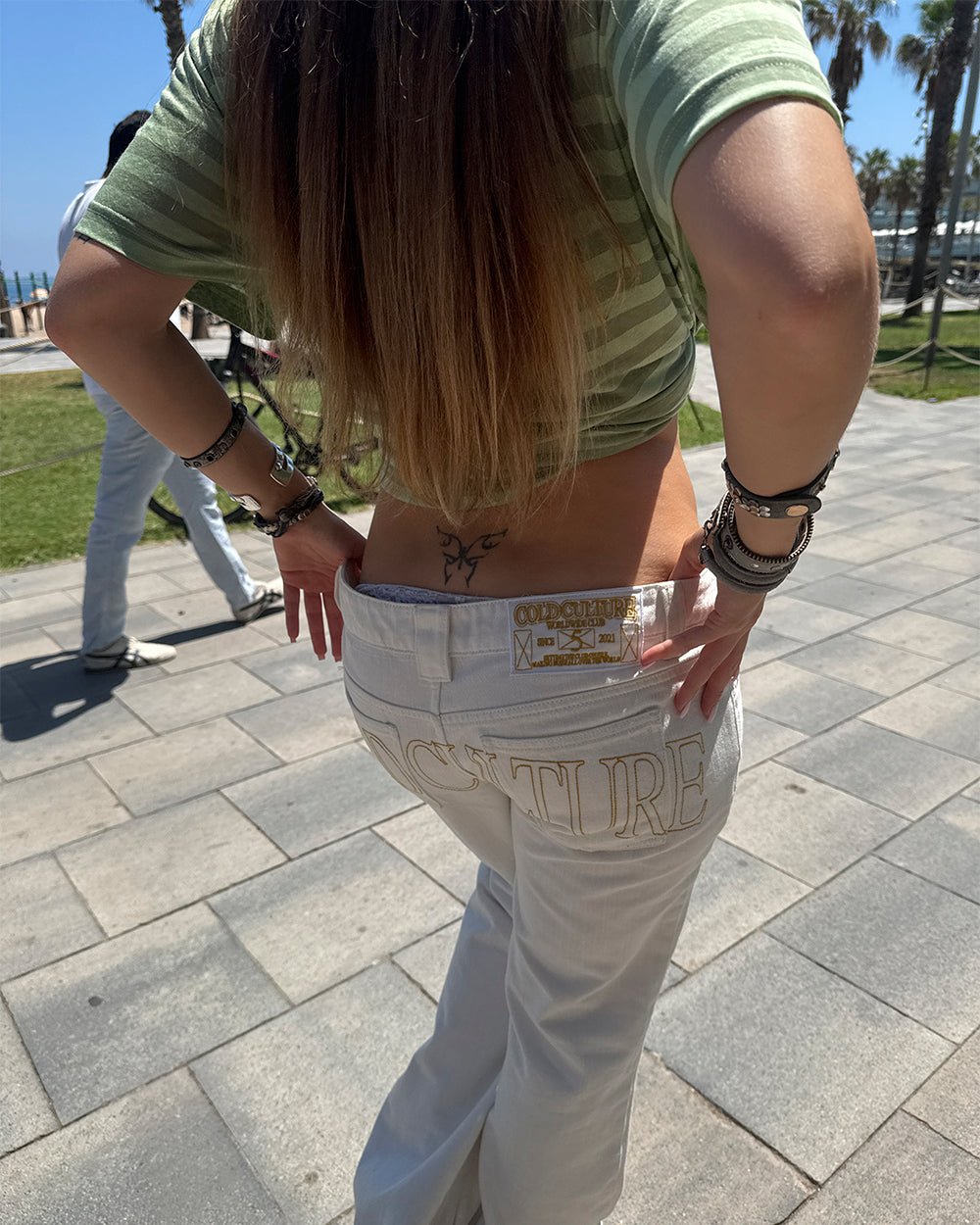 STIRRUP BOOTCUT WHITE - white bootcut pants, street style shot - Cold Culture #woman