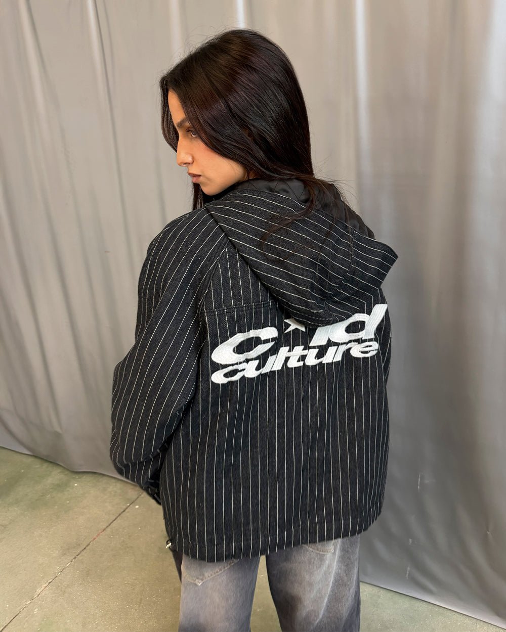 STRIPES CASINO JACKET NAVY - navy pinstripe hooded jacket, back view on female model - Cold Culture #woman